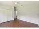 Spacious bedroom with hardwood floors, closet, ceiling fan and bright natural light at 27012 Sea Breeze Way, Wesley Chapel, FL 33544
