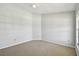 Large bedroom features neutral carpet, ceiling fan, bright natural light from the windows at 27012 Sea Breeze Way, Wesley Chapel, FL 33544
