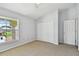 Bright bedroom with neutral carpet, dual closets, ceiling fan and bright natural light at 27012 Sea Breeze Way, Wesley Chapel, FL 33544