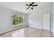 Bedroom features a large window providing natural light, and a ceiling fan at 27012 Sea Breeze Way, Wesley Chapel, FL 33544
