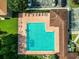 Overhead view of a sparkling community pool with ample lounge chairs, parking, and lush landscaping at 27012 Sea Breeze Way, Wesley Chapel, FL 33544
