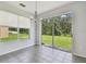 Bright dining area with sliding glass doors, tile floor, and natural light overlooking the backyard at 27012 Sea Breeze Way, Wesley Chapel, FL 33544