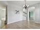 Dining room featuring wood floors, a decorative light fixture and arched doorways at 27012 Sea Breeze Way, Wesley Chapel, FL 33544