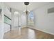 Well-lit dining area with wood floors, arched doorways, and natural light at 27012 Sea Breeze Way, Wesley Chapel, FL 33544