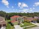Two-story home with manicured lawn and landscaping on a sunny day at 27012 Sea Breeze Way, Wesley Chapel, FL 33544
