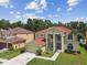 Two-story home with manicured lawn, fountain, and landscaping on a sunny day at 27012 Sea Breeze Way, Wesley Chapel, FL 33544