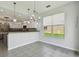 Bright kitchen with an island, stainless appliances, tile flooring, and natural light at 27012 Sea Breeze Way, Wesley Chapel, FL 33544