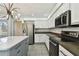 Spacious kitchen with a stainless steel refrigerator, range, microwave, ample cabinets, and a central island at 27012 Sea Breeze Way, Wesley Chapel, FL 33544