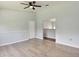 The living room features light-colored wood floors, neutral walls, and a ceiling fan at 27012 Sea Breeze Way, Wesley Chapel, FL 33544