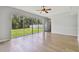 Bright living room with hardwood floors, large sliding glass doors, and natural light at 27012 Sea Breeze Way, Wesley Chapel, FL 33544