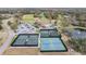 Aerial view of tennis courts and community clubhouse with golf course in the background at 2769 St Andrews Blvd, Tarpon Springs, FL 34688