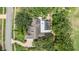 Aerial view of a home with a pool, lush trees, and a winding driveway at 2769 St Andrews Blvd, Tarpon Springs, FL 34688