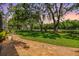 Picturesque backyard featuring a brick paver patio and well-manicured lawn and mature trees at 2769 St Andrews Blvd, Tarpon Springs, FL 34688