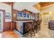 An elaborate bar area showcases stone countertops, wood paneling and seating for three at 2769 St Andrews Blvd, Tarpon Springs, FL 34688