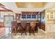This bar area has stone countertops, wood paneling and three chairs at 2769 St Andrews Blvd, Tarpon Springs, FL 34688