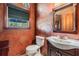 Elegant bathroom featuring ornate mirror and patterned walls at 2769 St Andrews Blvd, Tarpon Springs, FL 34688