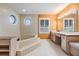 Large bathroom featuring a soaking tub, decorative window, and vanity with a long mirror at 2769 St Andrews Blvd, Tarpon Springs, FL 34688