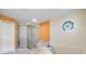 Orange accented bathroom features an octagonal window, shower, and large soaking tub at 2769 St Andrews Blvd, Tarpon Springs, FL 34688
