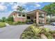 Exterior view of Cypress Run's clubhouse with porte cochere, surrounded by lush greenery and manicured landscaping at 2769 St Andrews Blvd, Tarpon Springs, FL 34688