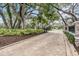 Long driveway leading into Cypress Run with mature trees and manicured landscape on either side at 2769 St Andrews Blvd, Tarpon Springs, FL 34688