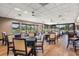Dining room with tables, chairs, and large windows providing natural light and golf course views at 2769 St Andrews Blvd, Tarpon Springs, FL 34688