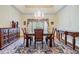 Elegant dining room showcases a classic chandelier, decorative rug, and detailed wall trim at 2769 St Andrews Blvd, Tarpon Springs, FL 34688