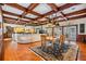 Open concept dining room area with wooden ceiling beams and wood floors at 2769 St Andrews Blvd, Tarpon Springs, FL 34688