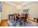 Formal dining room featuring a chandelier, beautiful trim, and a view to the front yard at 2769 St Andrews Blvd, Tarpon Springs, FL 34688
