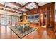 Dining room with hardwood floors, wood paneling, and custom cabinets with windows and natural light at 2769 St Andrews Blvd, Tarpon Springs, FL 34688