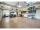 Spacious garage features finished floor, overhead storage, and room for golf cart at 2769 St Andrews Blvd, Tarpon Springs, FL 34688