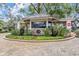 Community guard house at Cypress Run with stone accents, lush landscaping, and well-maintained grounds at 2769 St Andrews Blvd, Tarpon Springs, FL 34688
