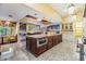 Expansive kitchen with a large island, modern appliances, and seamless transition to the dining areas at 2769 St Andrews Blvd, Tarpon Springs, FL 34688