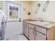 Laundry room features storage cabinets, countertops, and a door to the outside at 2769 St Andrews Blvd, Tarpon Springs, FL 34688