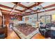 Open concept living room area with wooden ceiling beams and wood floors at 2769 St Andrews Blvd, Tarpon Springs, FL 34688