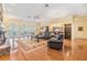 Spacious living room with hardwood floors, fireplace, and French doors leading to outdoor space at 2769 St Andrews Blvd, Tarpon Springs, FL 34688