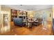 Cozy living room with a brick fireplace, hardwood floors, and large windows at 2769 St Andrews Blvd, Tarpon Springs, FL 34688