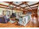 Spacious living room area with wooden ceiling beams and wood floors at 2769 St Andrews Blvd, Tarpon Springs, FL 34688