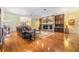 Open living room boasts a brick fireplace and hardwood floors, creating a cozy and inviting atmosphere at 2769 St Andrews Blvd, Tarpon Springs, FL 34688