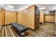 A spacious locker room with wood lockers, bench and vintage-inspired wallpaper detail at 2769 St Andrews Blvd, Tarpon Springs, FL 34688
