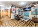 Lounge with framed sports jersey, chaise lounge, and quirky carpet at 2769 St Andrews Blvd, Tarpon Springs, FL 34688