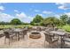 Outdoor patio featuring tables, chairs, manicured landscaping, and fire pit at 2769 St Andrews Blvd, Tarpon Springs, FL 34688