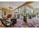 Screened-in patio showcases a fire pit, pillars, brick, and an in-ground pool at 2769 St Andrews Blvd, Tarpon Springs, FL 34688