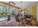 Screened in patio provides in ground pool views, pillars, and outdoor seating at 2769 St Andrews Blvd, Tarpon Springs, FL 34688