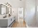 Bright bathroom featuring double vanity, modern fixtures, and a glass-enclosed shower with marble tile at 2814 Graphite Ct, Valrico, FL 33594