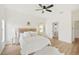 Bright bedroom with light floors, ceiling fan, decorative headboard, and a connecting bathroom at 2814 Graphite Ct, Valrico, FL 33594