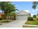 Charming one-story home with a well-manicured lawn and a two-car garage on a sunny day at 2814 Graphite Ct, Valrico, FL 33594