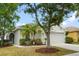Charming home featuring a well-maintained yard with mature landscaping and a two-car garage at 2814 Graphite Ct, Valrico, FL 33594