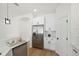 Modern kitchen features stainless steel refrigerator, white cabinets, and white subway tile backsplash at 2814 Graphite Ct, Valrico, FL 33594