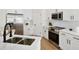 Modern kitchen features stainless steel refrigerator, oven, white cabinets and subway tile backsplash at 2814 Graphite Ct, Valrico, FL 33594