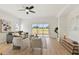 Bright living room with wood-look floors, neutral furniture, ceiling fan, and sliding glass doors to the backyard at 2814 Graphite Ct, Valrico, FL 33594